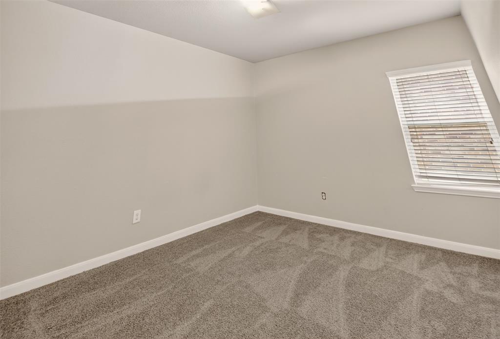 9105 Switchgrass Lane Forney, TX 75126 - Photo 7 of 20 Room featuring light grey carpeting, white baseboards, and neutral wall paint