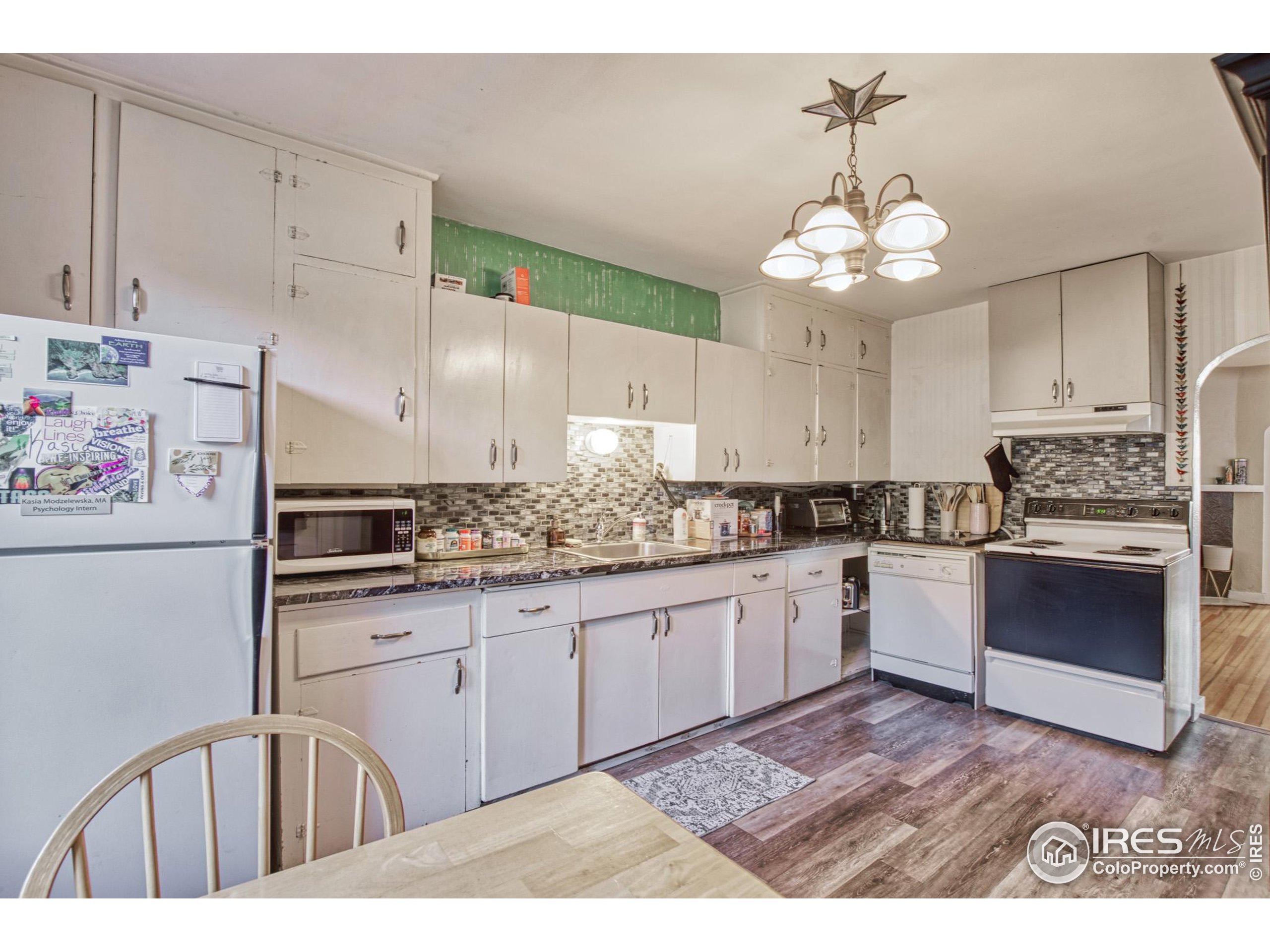 530 Mathews Street Fort Collins, CO 80524 - Photo 12 of 34 a kitchen with cabinets a center island and appliances