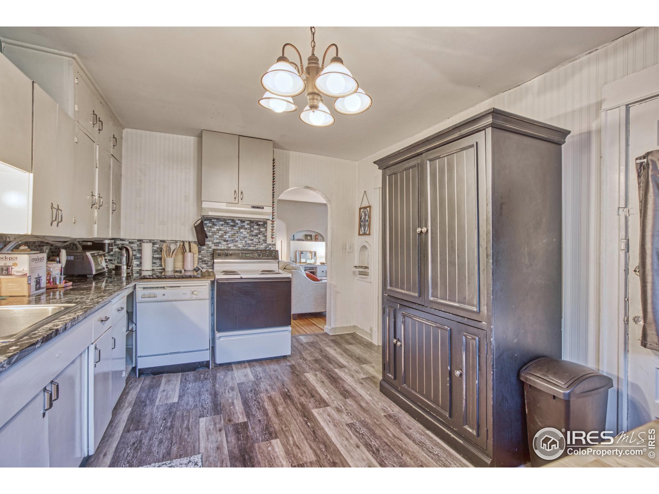 530 Mathews Street Fort Collins, CO 80524 - Photo 13 of 34 a kitchen with stainless steel appliances granite countertop a refrigerator a sink dishwasher a stove and white cabinets with wooden floor