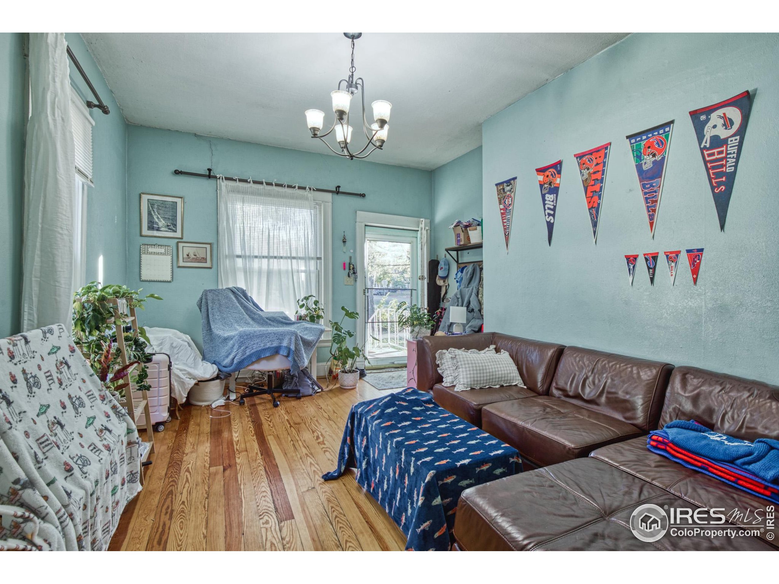 530 Mathews Street Fort Collins, CO 80524 - Photo 16 of 34 a living room with furniture and a chandelier