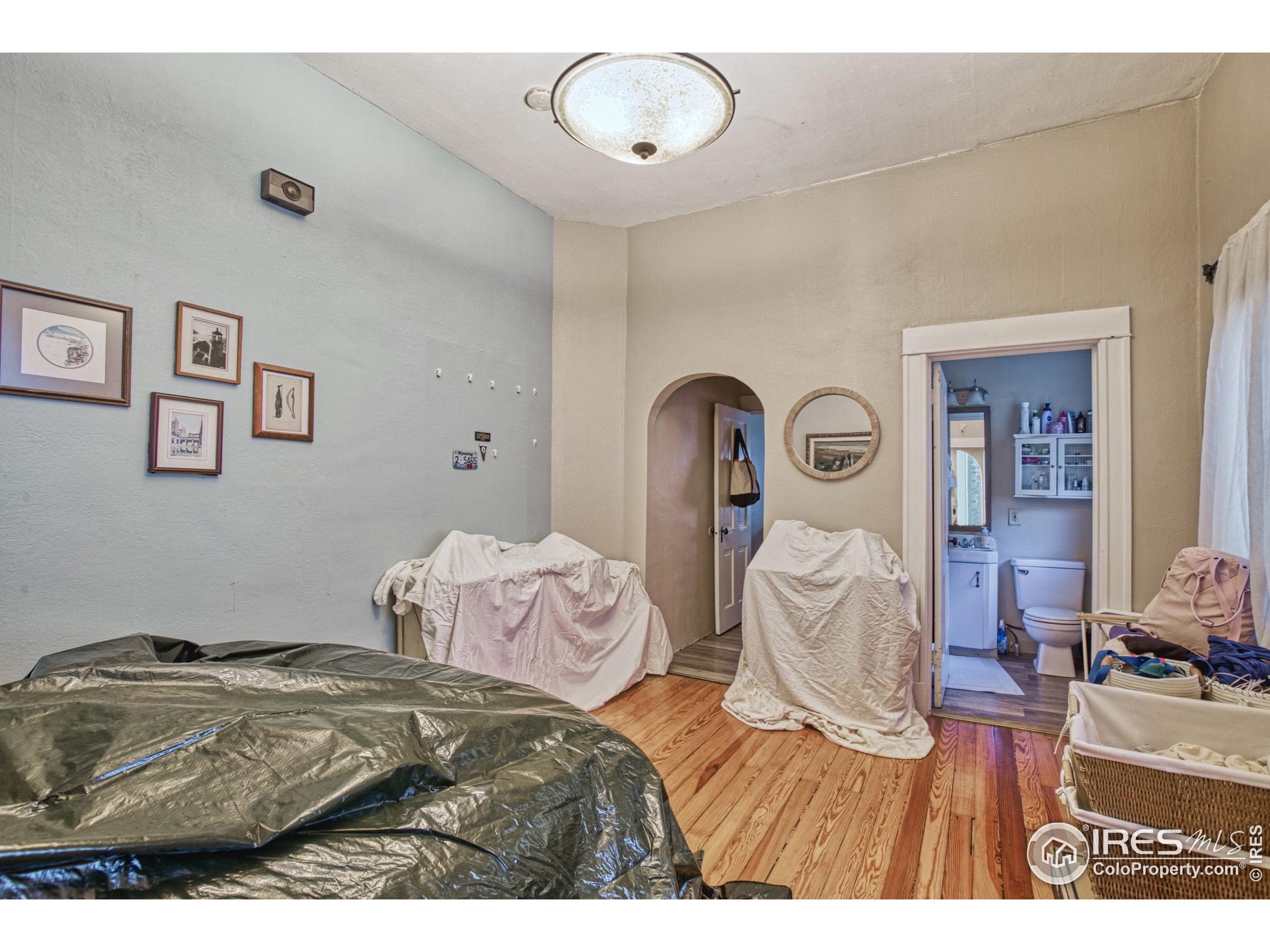 530 Mathews Street Fort Collins, CO 80524 - Photo 17 of 34 a bedroom with a bed and a chandelier