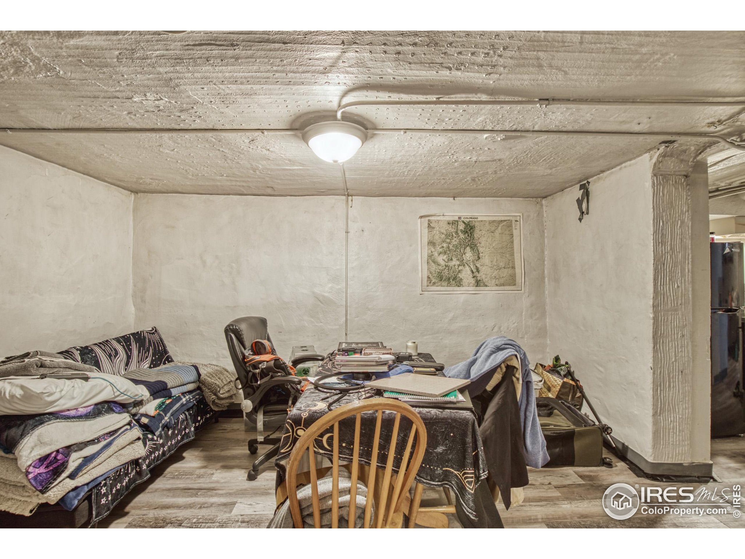 530 Mathews Street Fort Collins, CO 80524 - Photo 23 of 34 a bedroom with a bed and a table