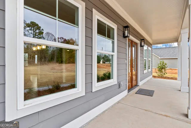 a view of an empty room with a fireplace and a window