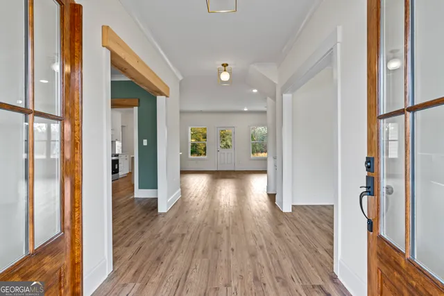 a view of a kitchen with a stove cabinets a ceiling fan and wooden floor