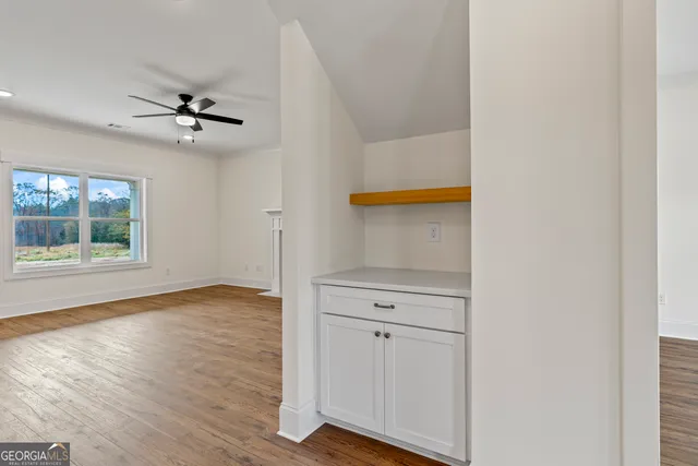 a kitchen with a sink a stove a refrigerator and white cabinets