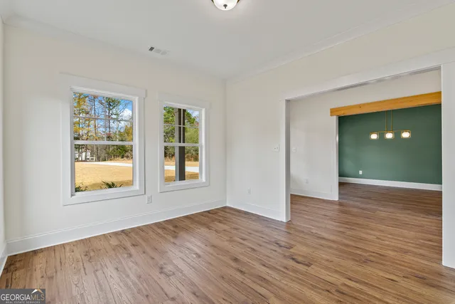 a kitchen with stove cabinets and wooden floor