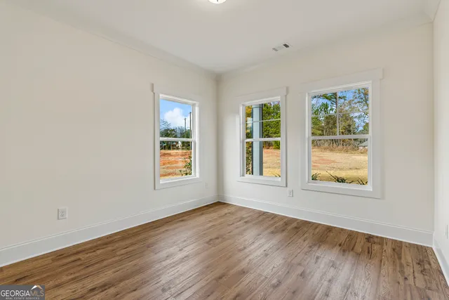 a kitchen with stainless steel appliances a sink a stove a refrigerator and white cabinets