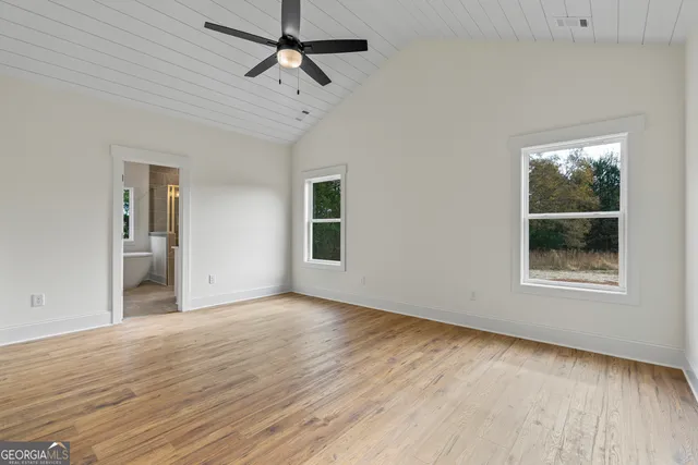 an empty room with windows and closet