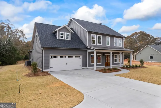 an empty room with wooden floor cabinet and windows