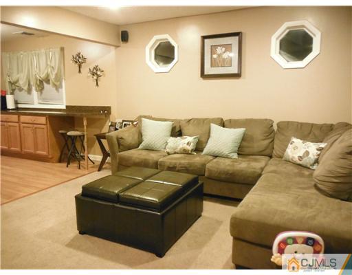 61 Glenville Road Edison, NJ 08817 - Photo 6 of 10 a living room with furniture and wall paintings