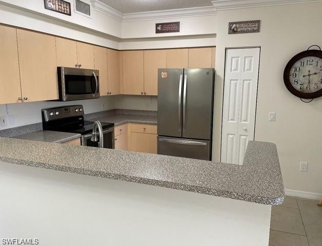 1180 Reserve Way, Unit 206 Naples, FL 34105 - Photo 2 of 18 a kitchen with stainless steel appliances granite countertop a refrigerator a stove and a sink with wooden floor
