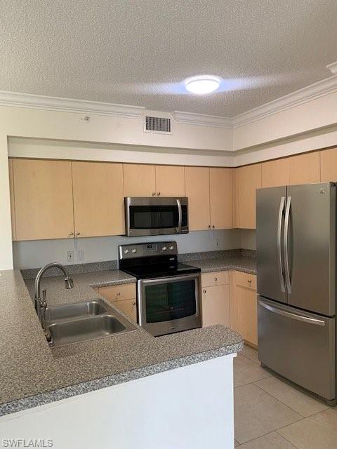1180 Reserve Way, Unit 206 Naples, FL 34105 - Photo 3 of 18 a kitchen with stainless steel appliances granite countertop a refrigerator sink and stove