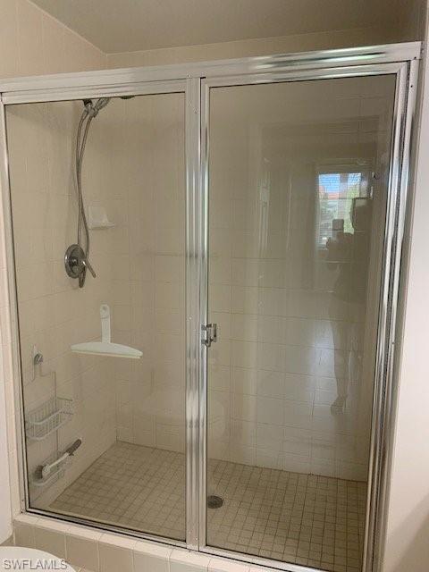 1180 Reserve Way, Unit 206 Naples, FL 34105 - Photo 7 of 18 a bathroom with a glass shower door