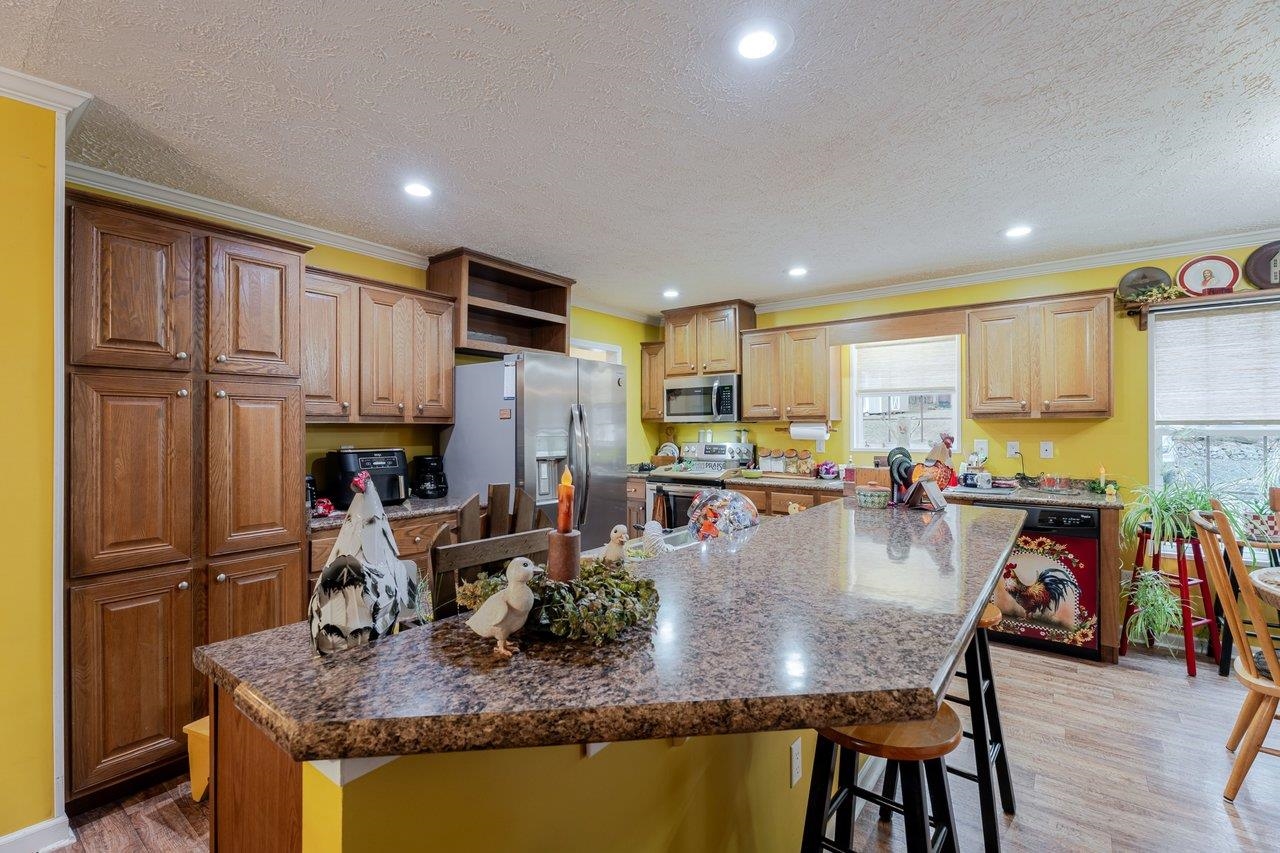 523 Gravels Road Harrisonburg, VA 22802 - Photo 12 of 65 a kitchen with stainless steel appliances granite countertop a refrigerator dining table and chairs