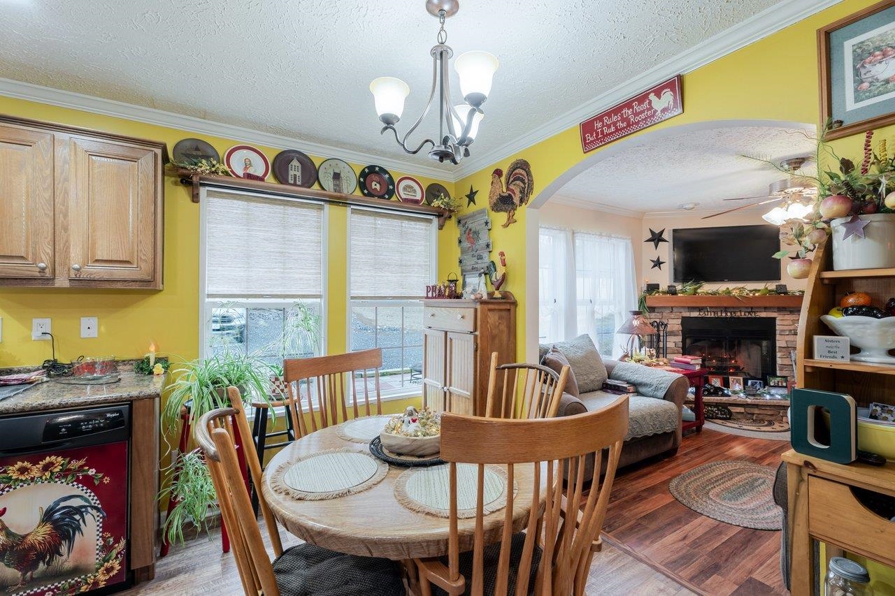 523 Gravels Road Harrisonburg, VA 22802 - Photo 17 of 65 a view of a dining room with furniture a chandelier and wooden floor