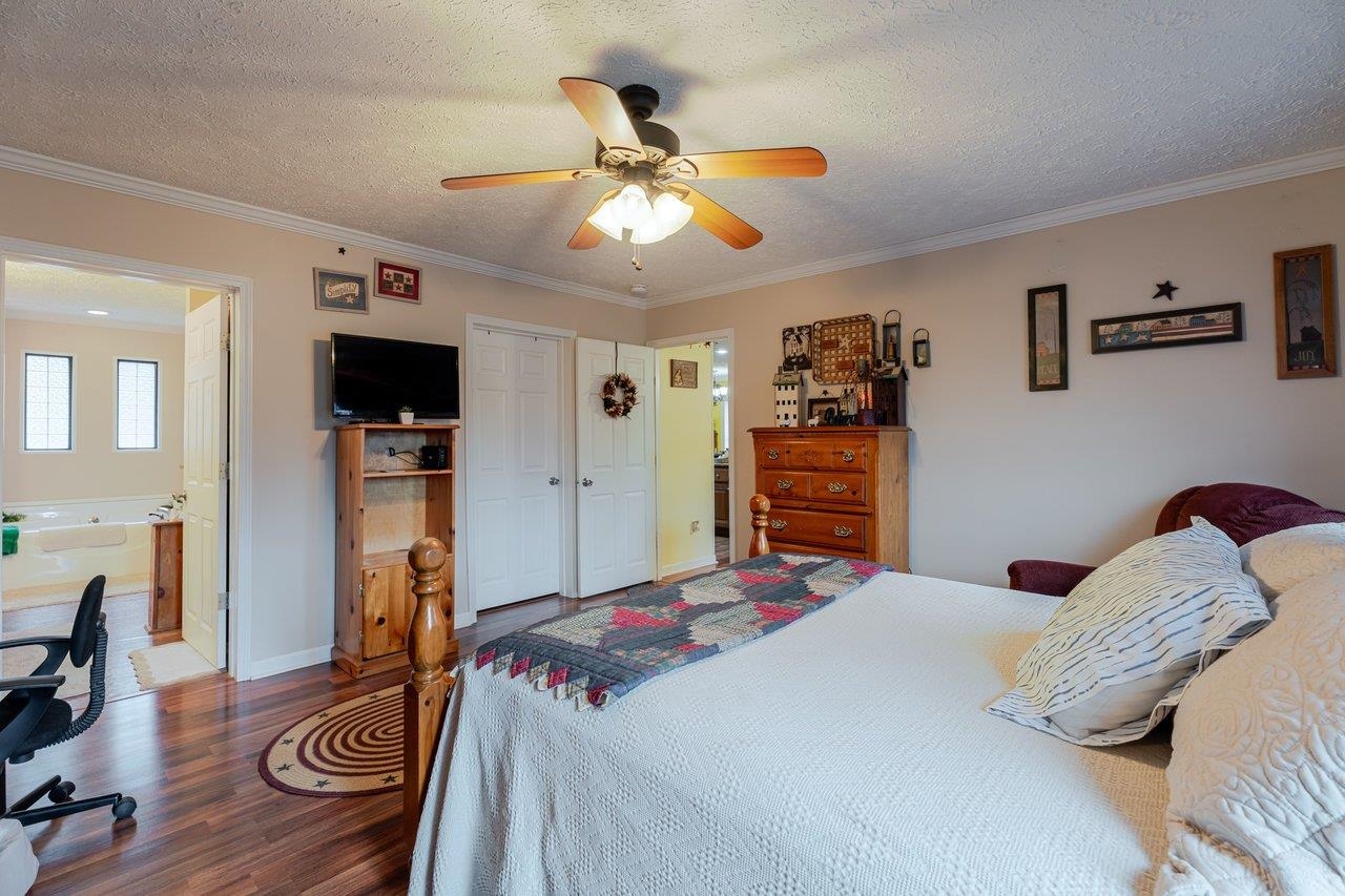 523 Gravels Road Harrisonburg, VA 22802 - Photo 23 of 65 a bedroom with a bed and a chandelier