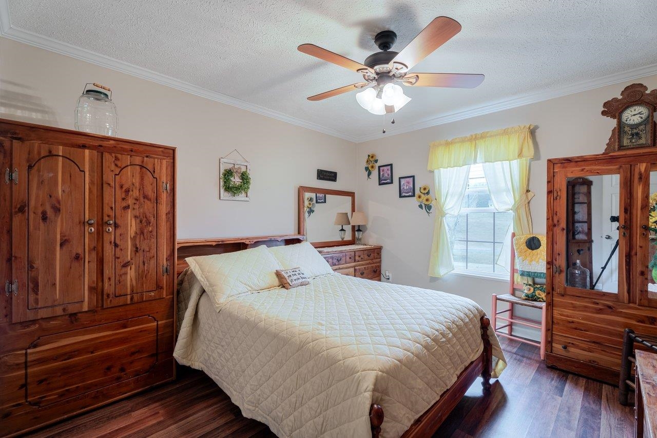 523 Gravels Road Harrisonburg, VA 22802 - Photo 29 of 65 a bedroom with a large bed and a chandelier