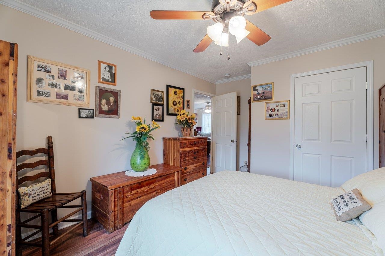 523 Gravels Road Harrisonburg, VA 22802 - Photo 30 of 65 a bedroom with a bed and a chandelier