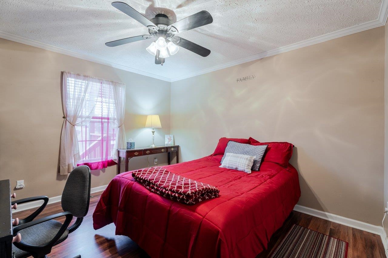 523 Gravels Road Harrisonburg, VA 22802 - Photo 31 of 65 a bedroom with a bed a chandelier and a chair