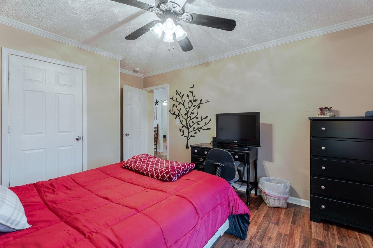 523 Gravels Road Harrisonburg, VA 22802 - Photo 32 of 65 a bedroom with a bed and a flat tv screen on dresser