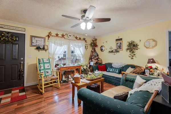 a kitchen with stainless steel appliances granite countertop a refrigerator dining table and chairs