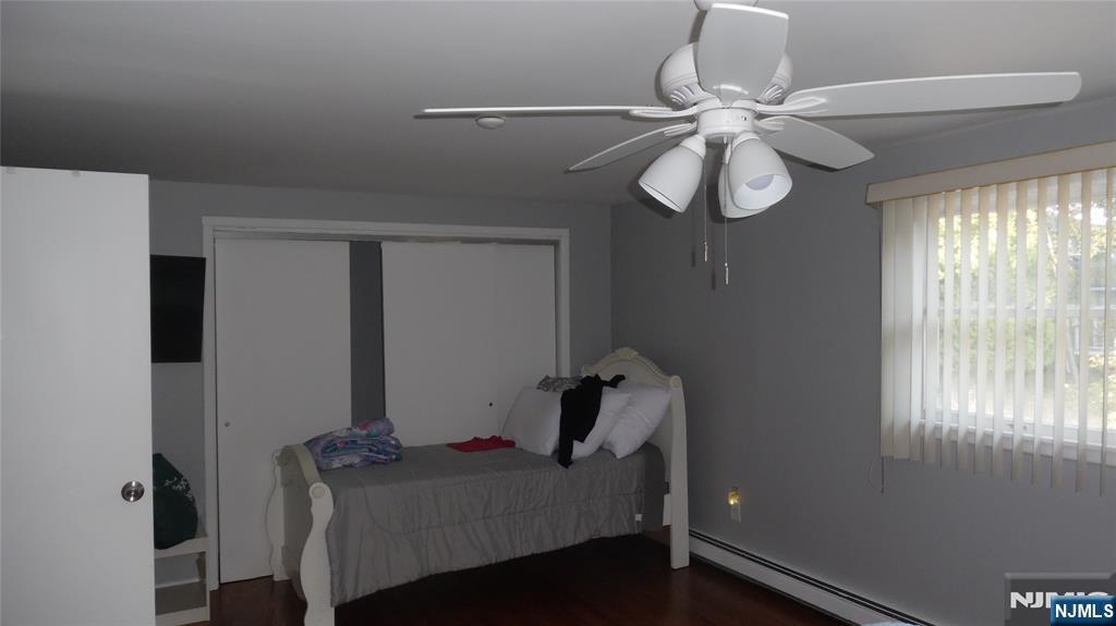 26 James Terrace Pompton Lakes, NJ 07442 - Photo 34 of 43 a bedroom with a bed and a chandelier