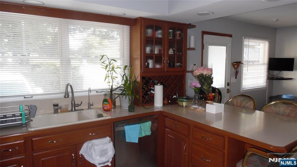 26 James Terrace Pompton Lakes, NJ 07442 - Photo 7 of 43 a kitchen with a sink and wooden cabinets