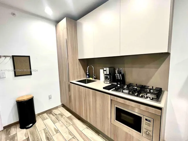 a kitchen with stainless steel appliances a stove a microwave and cabinets