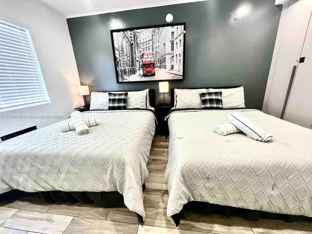 a bedroom with a bed and wall painting