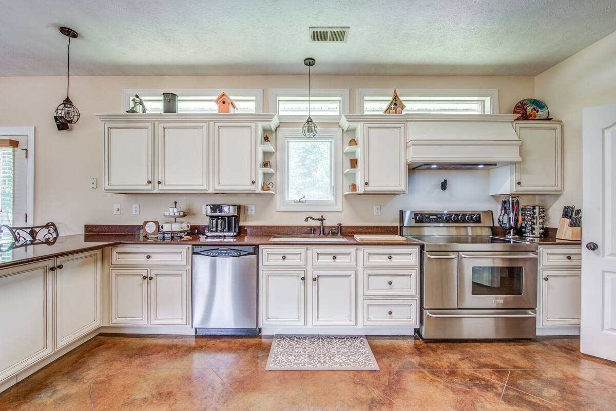 1215 Beaver Creek Road Mason, TN 38049 - Photo 21 of 74 a kitchen with stainless steel appliances granite countertop a sink and cabinets