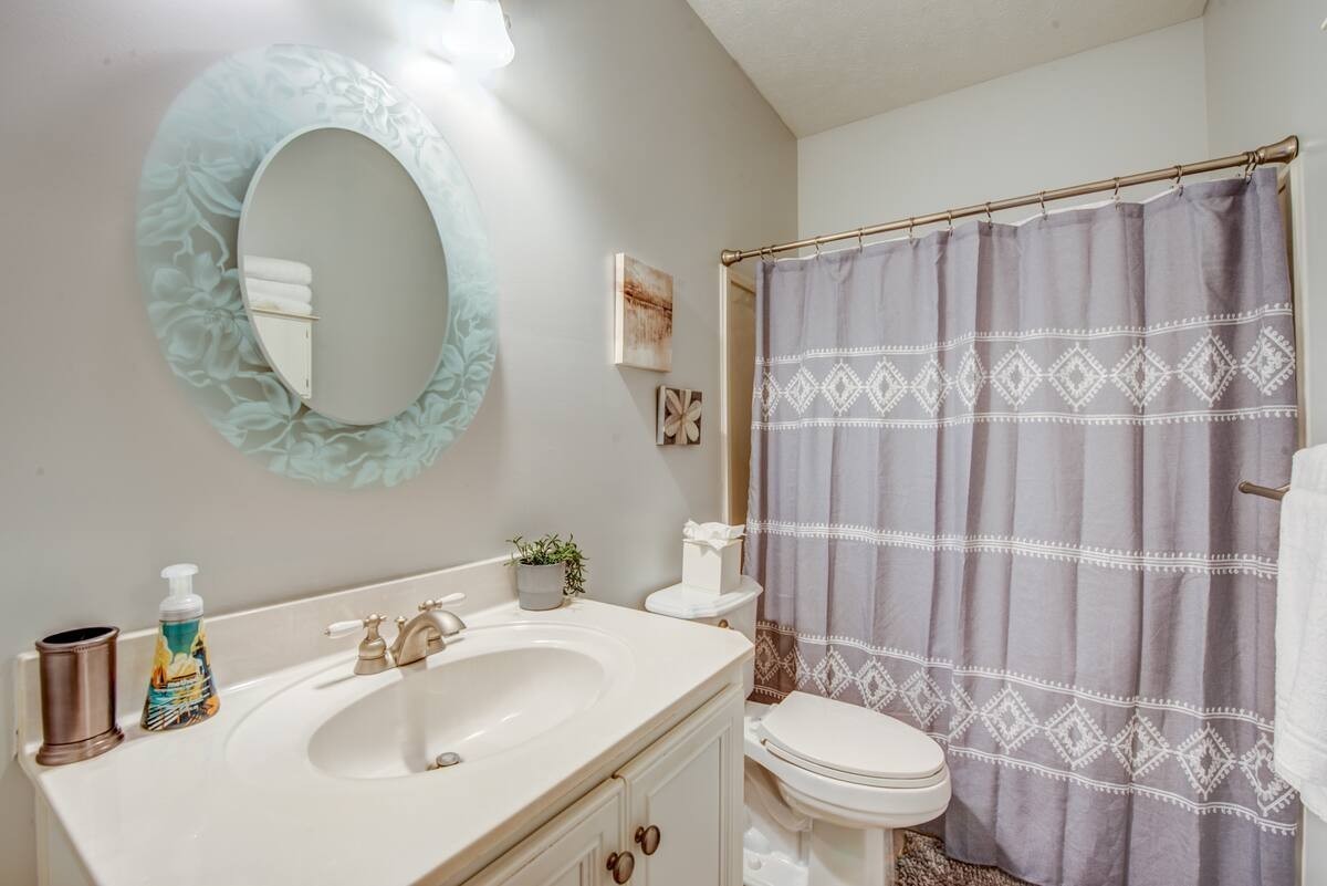 1215 Beaver Creek Road Mason, TN 38049 - Photo 36 of 74 a bathroom with a toilet sink and mirror