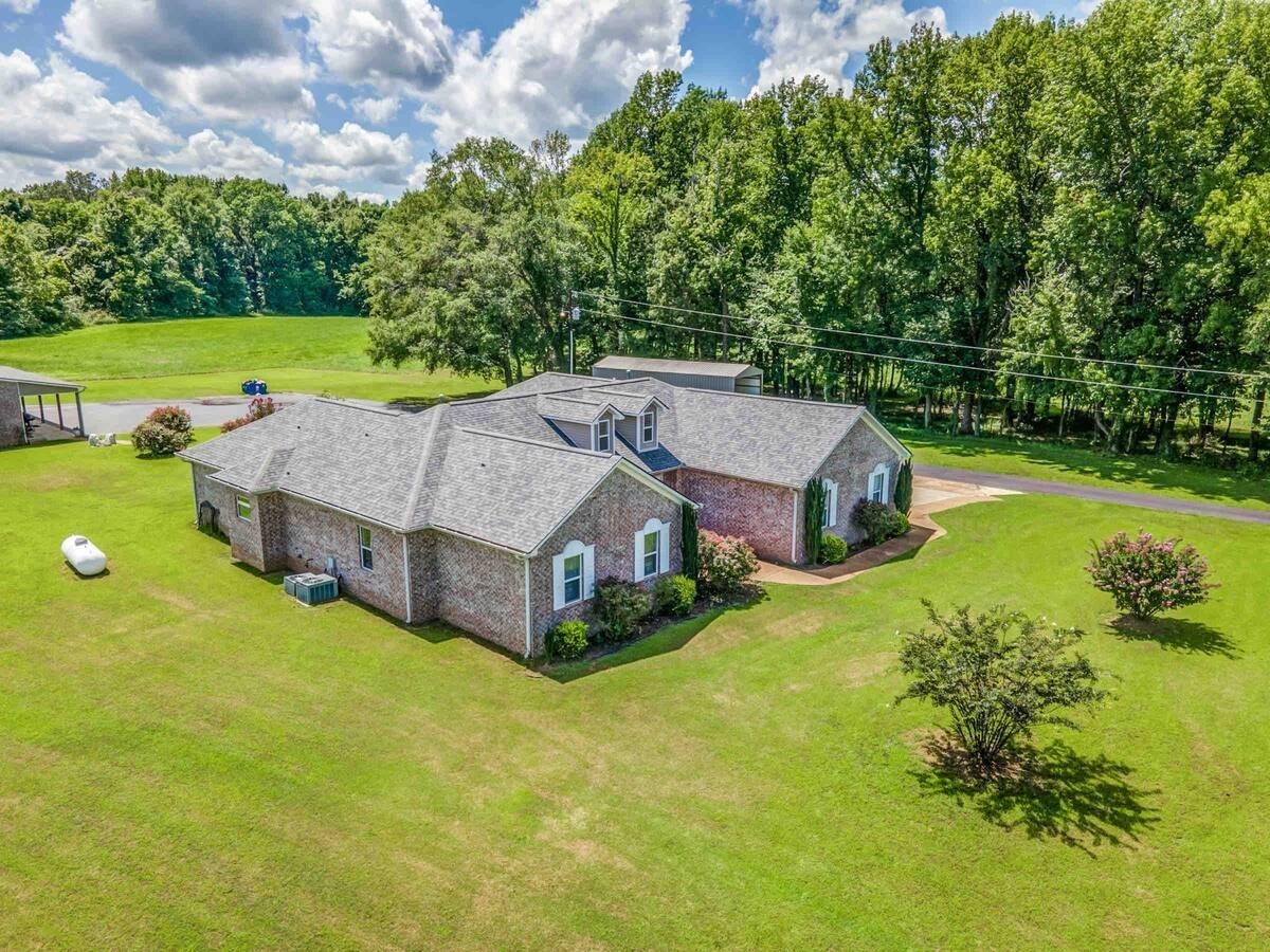 1215 Beaver Creek Road Mason, TN 38049 - Photo 4 of 74 a aerial view of a house with swimming pool and garden