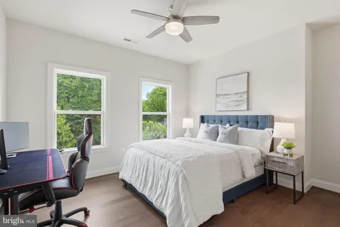 a bedroom with a bed window and a desk