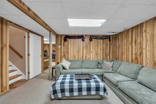 a living room with furniture and a ceiling fan