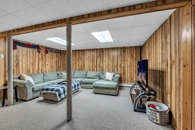 a living room with furniture a window and gym equipment