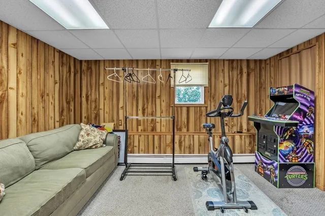 a living room with furniture and a gym machine