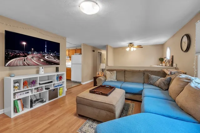 a living room with furniture and a book shelf
