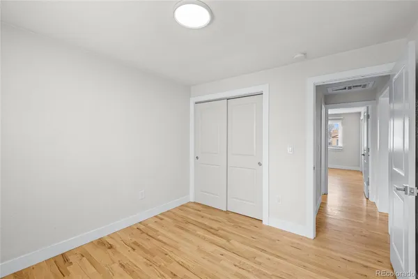 a view of a room with wooden floor and bathroom
