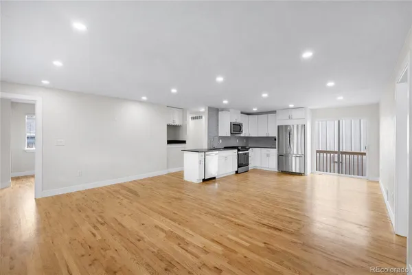a view of kitchen with kitchen island and stainless steel appliances