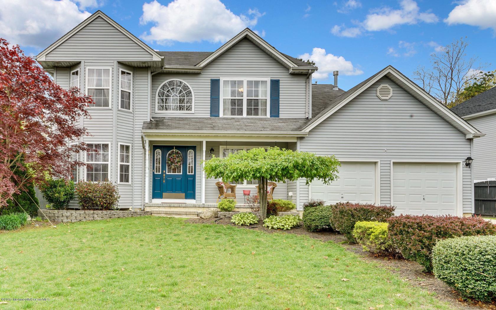 133 Bowsprit Road Manahawkin, NJ 08050 - Photo 1 of 32 a front view of a house with a yard and garage