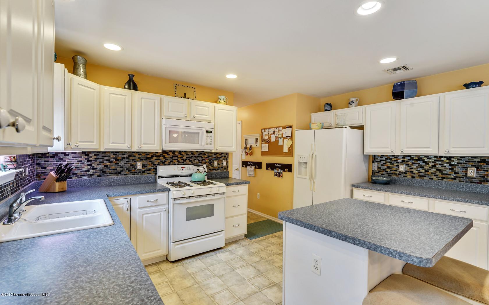 133 Bowsprit Road Manahawkin, NJ 08050 - Photo 11 of 32 a kitchen with a stove a refrigerator and a sink