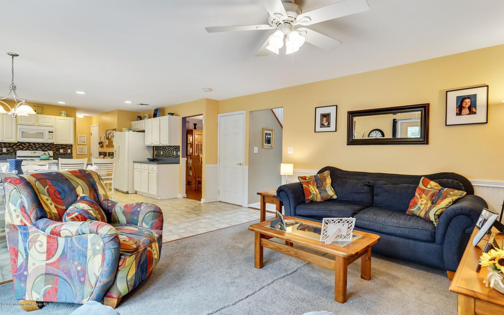 133 Bowsprit Road Manahawkin, NJ 08050 - Photo 14 of 32 a living room with furniture kitchen view and a chandelier