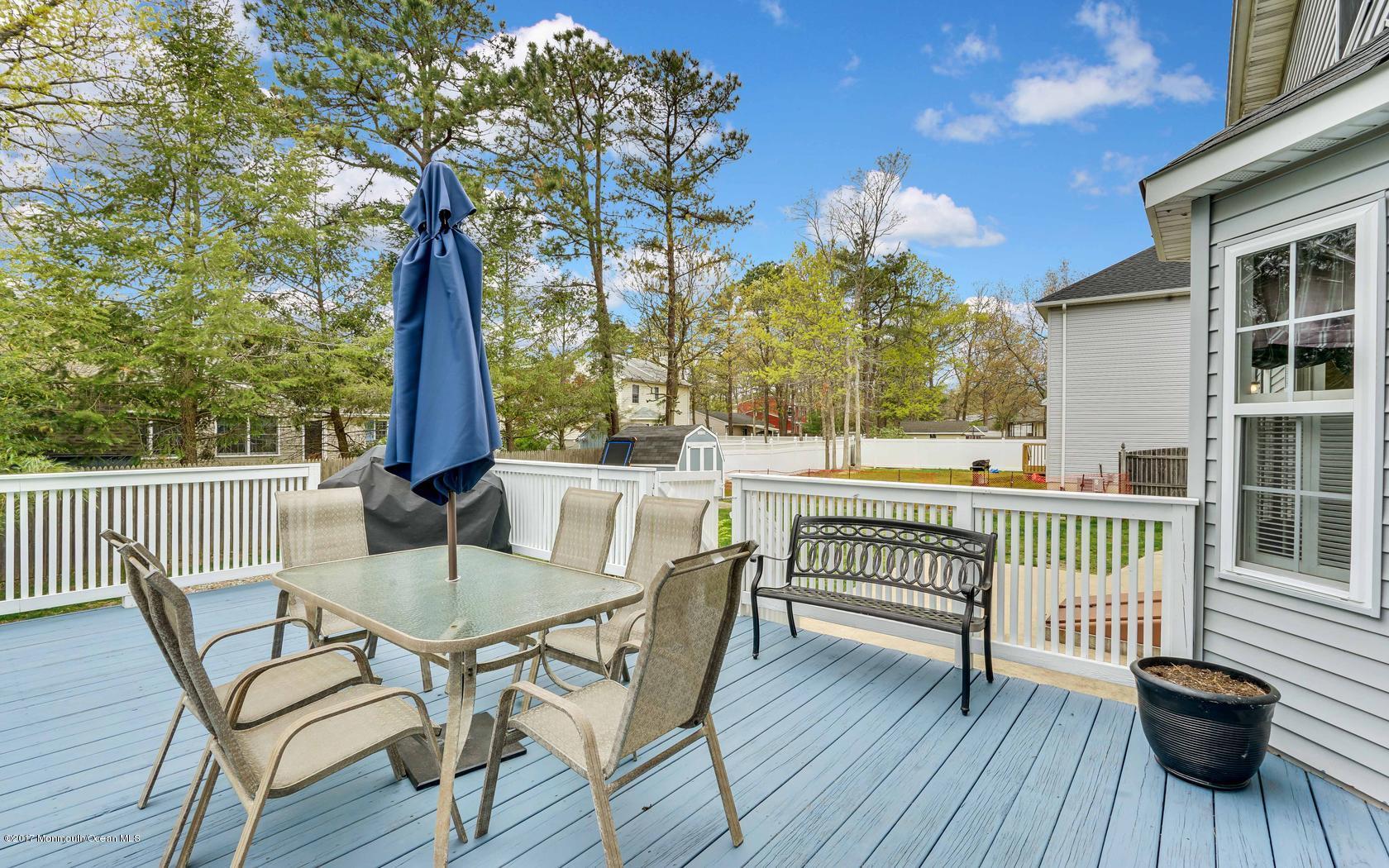133 Bowsprit Road Manahawkin, NJ 08050 - Photo 24 of 32 a view of a chair and table in the balcony