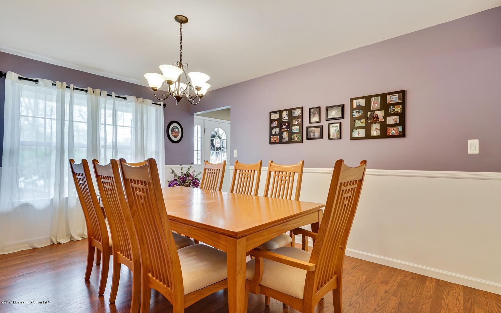 133 Bowsprit Road Manahawkin, NJ 08050 - Photo 8 of 32 a view of a dining room with furniture a chandelier and wooden floor