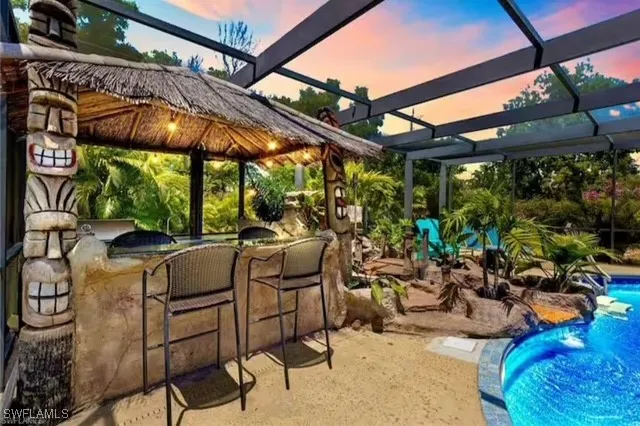 a view of patio with a table and chairs under an umbrella