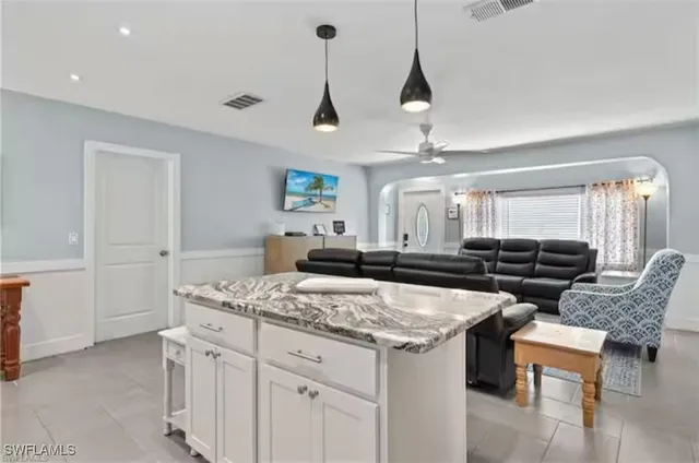 a kitchen with a stove a sink a dining table and chairs