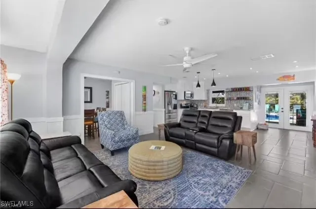 a living room with furniture and wooden floor
