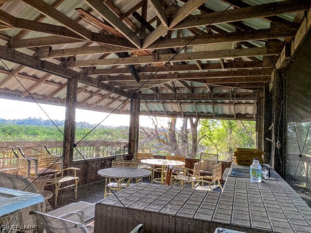 Camelia Street LaBelle, FL 33935 - Photo 3 of 15 a view of a patio with table and chairs a barbeque with floor to ceiling windows