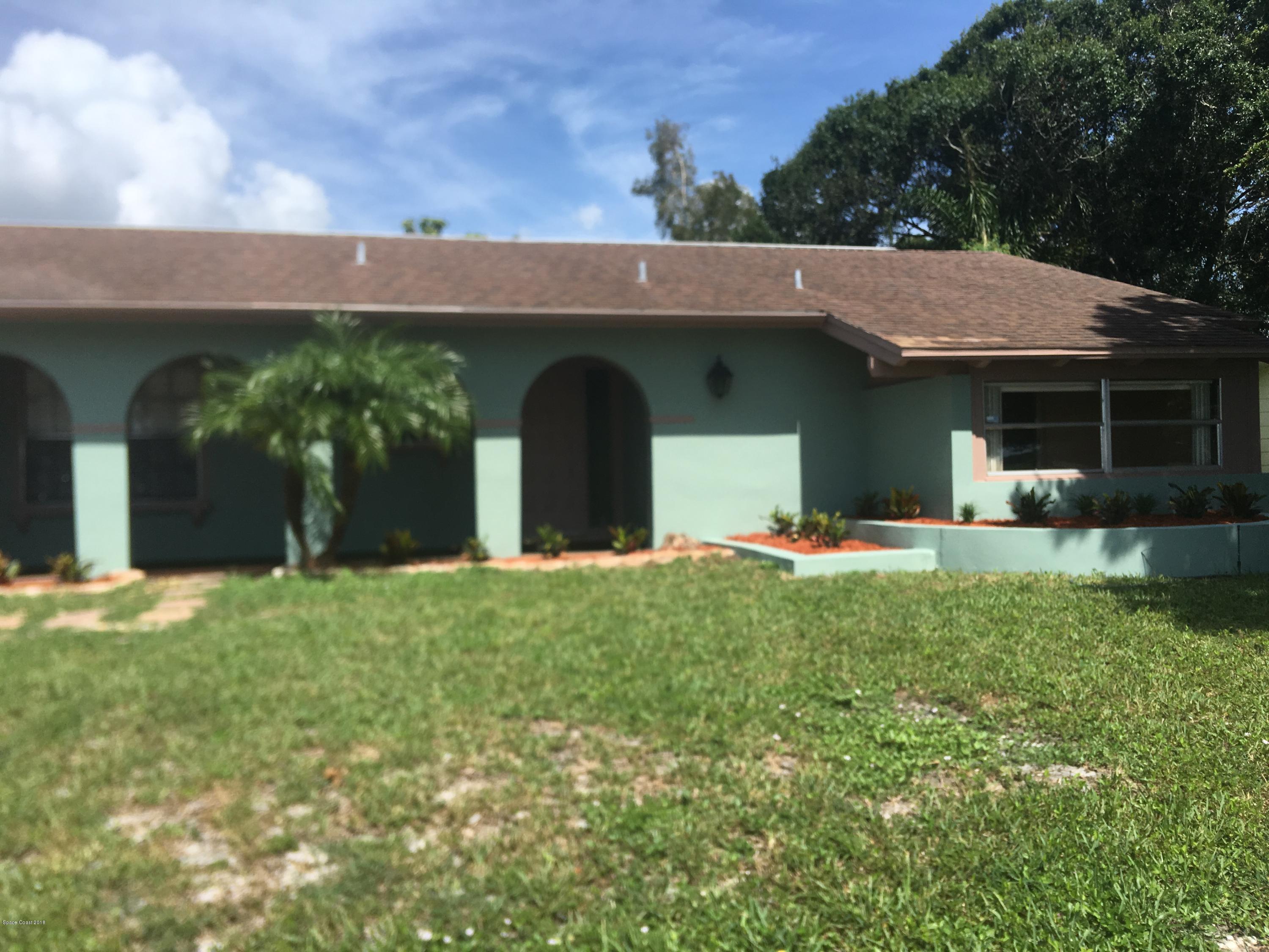 1272 Cromey Road Northeast Palm Bay, FL 32905 - Photo 3 of 53 a view of a house with a backyard and a garden