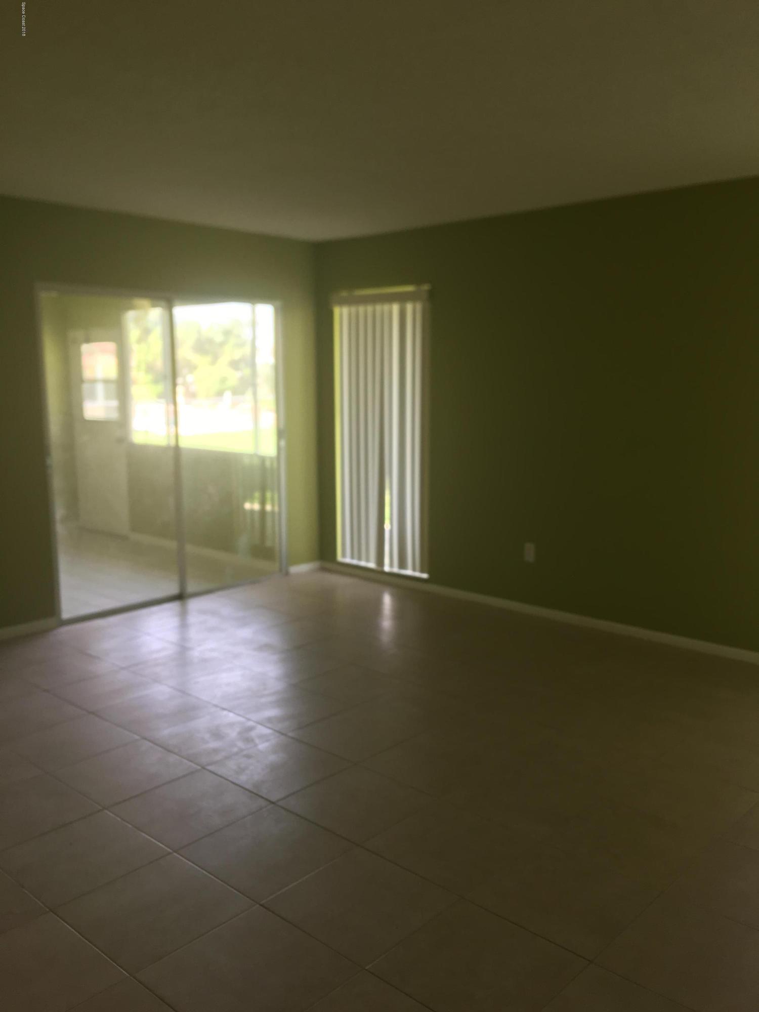 1272 Cromey Road Northeast Palm Bay, FL 32905 - Photo 22 of 53 a view of a livingroom with wooden floor and a window
